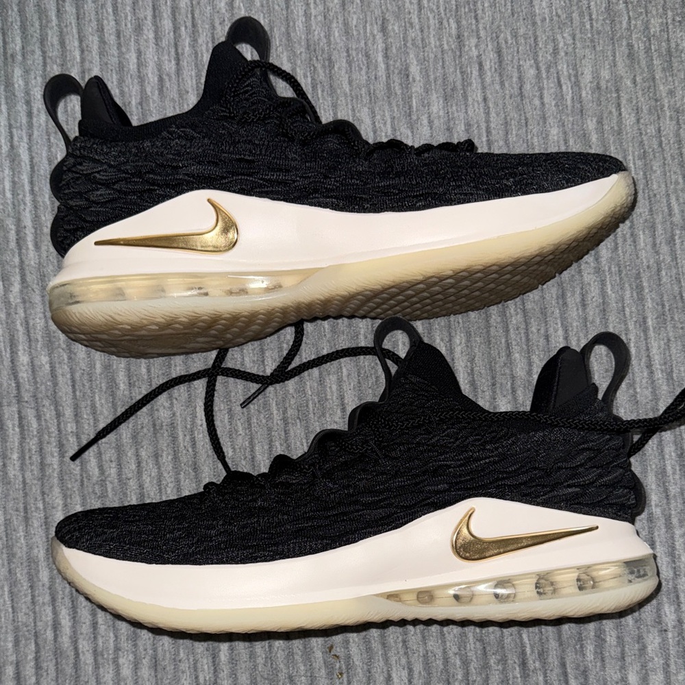 Nike LeBron 15 Low in the Black/Metallic Gold/Phantom colorway.